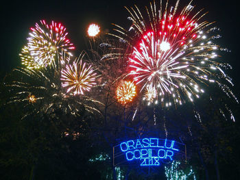 Low angle view of firework display at night