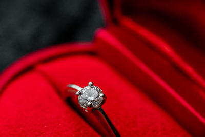 Close-up of red ring box with diamond ring