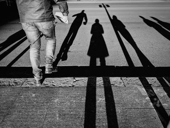 Low section of people walking on street