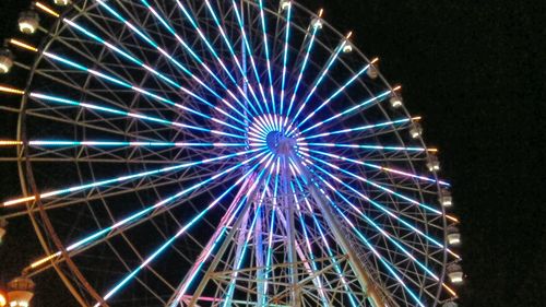 Low angle view of ferris wheel at night