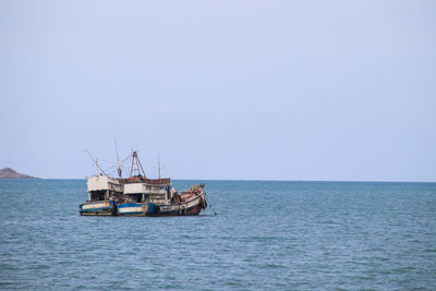 Two fishing boats landing on a beautiful sky