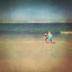 People on beach against sky