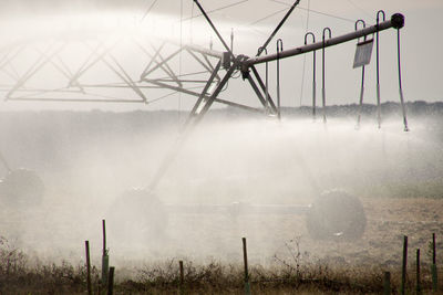 Scenic view of field against sky during foggy weather