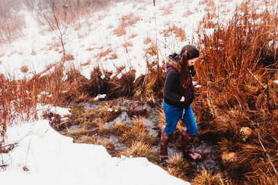 Girl walking on field during winter