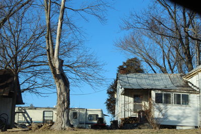 Abandoned house against clear blue sky