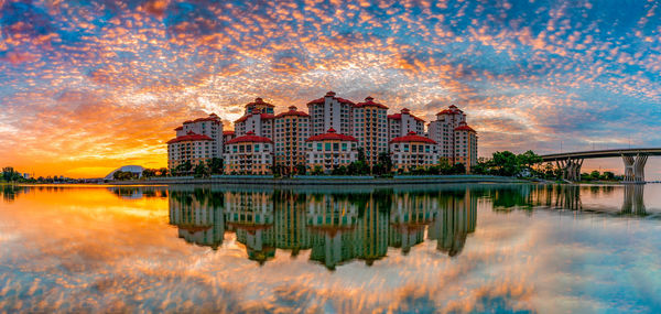 Reflection of building in lake at sunset