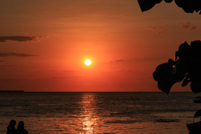 Scenic view of sea against orange sky