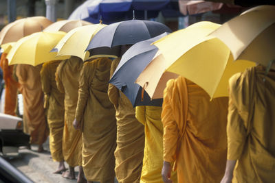 Rear view of people with umbrella