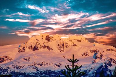 Scenic view of mountains against dramatic sky during sunset