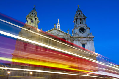 Low angle view of illuminated building against blue sky