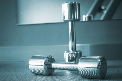 Close-up of dumbbells on floor at gym