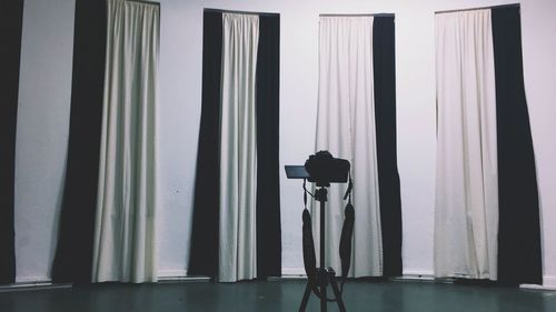 Man photographing against wall at home