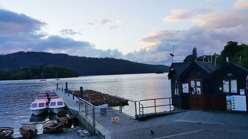 Pier on lake against cloudy sky