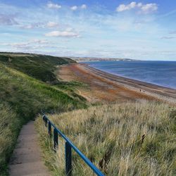 Scenic view of sea against cloudy sky