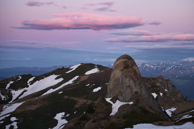 Scenic view of snowcapped mountains against sky during sunset