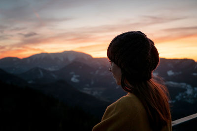 Portrait of man looking at mountains against sky