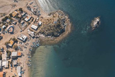 High angle view of sea and buildings in city