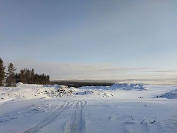 Scenic view of snow covered land against clear sky
