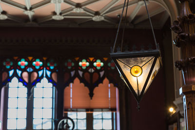 Low angle view of illuminated lanterns hanging on ceiling in building