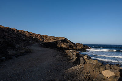 Scenic view of sea against clear blue sky