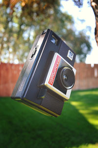 Close-up of camera against trees