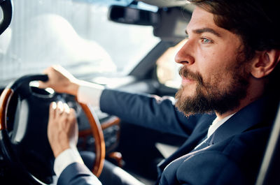 Portrait of young man in car