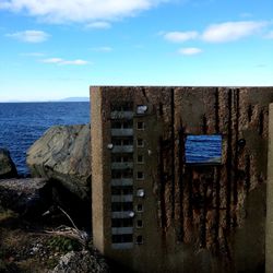 Built structure on beach against sky