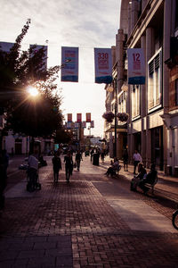 People walking on sidewalk in city