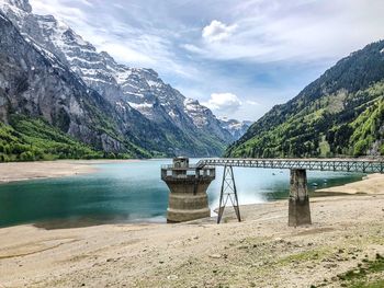 Scenic view of dam on lake against mountains