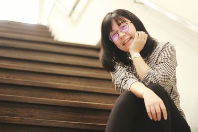 Smiling young woman using mobile phone