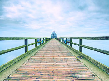 Pier over sea against sky