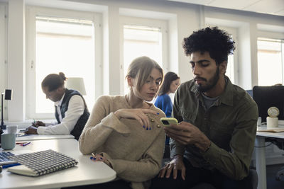 Two professionals discussing in office