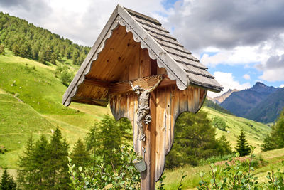 Built structure on field against sky