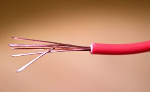 Close-up of colored pencils over pink background