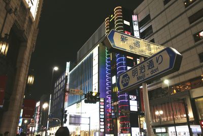 Low angle view of city lit up at night