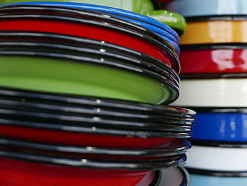 Close-up of multi colored plates with container