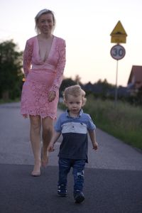 Full length of girl walking on road