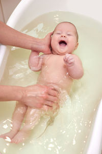 High angle view of woman washing hands in sink