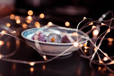 Close-up of illuminated cake on table