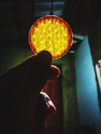 Close-up of hand holding illuminated light