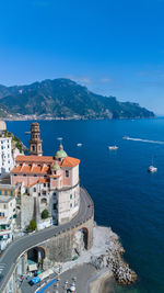 High angle view of townscape by sea against sky