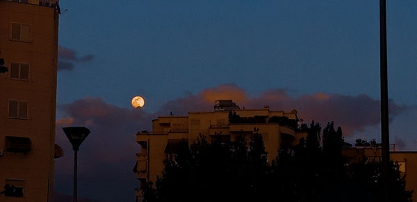 Low angle view of silhouette buildings against sky at night