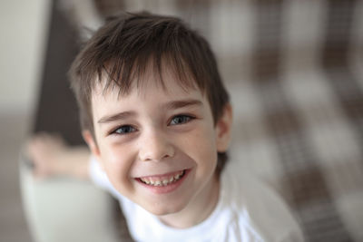 Portrait of boy child brunette with gray eyes, happy child, concept of happy childhood and emotions