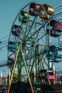 Low angle view of ferris wheel against sky