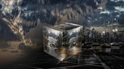 Digital composite image of glass and buildings on table