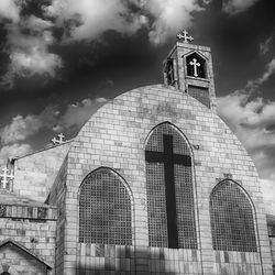 Low angle view of building against cloudy sky