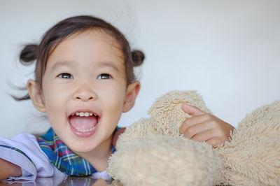 Portrait of cute baby boy on bed at home