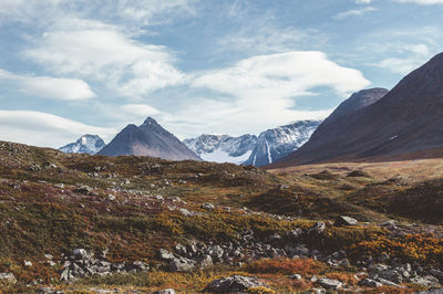 Scenic view of mountains against cloudy sky