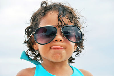 Portrait of woman wearing sunglasses against sky