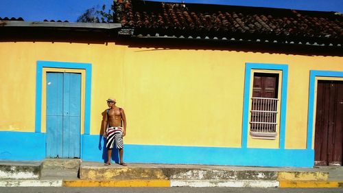 Full length of woman standing in front of building